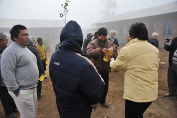 Passing Cooking Oil to Villagers